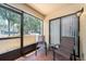 Relaxing screened patio with two chairs, a small table, and pleasant outdoor views at 105 Woodlake Wynde, Oldsmar, FL 34677