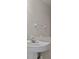The white sink and faucet is well lit by the vanity mirror at 1118 Kennewick Ct, Wesley Chapel, FL 33543