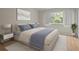 Bright bedroom featuring a window view, bedside tables, and comfortable bed at 1118 Kennewick Ct, Wesley Chapel, FL 33543