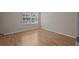 Bright bedroom with hardwood floors and a large window overlooking the outdoors at 1118 Kennewick Ct, Wesley Chapel, FL 33543