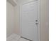 A modern white front door provides a clean and secure entrance to the home at 1118 Kennewick Ct, Wesley Chapel, FL 33543
