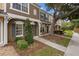 Charming townhouse exterior with neat landscaping and a quaint seating area on the porch at 1118 Kennewick Ct, Wesley Chapel, FL 33543