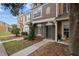 Attractive townhome showcasing a tidy lawn and sidewalk leading to a covered entry at 1118 Kennewick Ct, Wesley Chapel, FL 33543