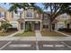 Inviting townhome featuring a well-manicured lawn, neutral exterior, and reserved visitor parking at 1118 Kennewick Ct, Wesley Chapel, FL 33543