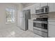 Efficient kitchen with stainless steel appliances, ample cabinet space, and bright tile flooring at 1118 Kennewick Ct, Wesley Chapel, FL 33543