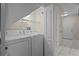 Bright laundry room featuring a washer, dryer, and convenient shelving for storage needs at 1118 Kennewick Ct, Wesley Chapel, FL 33543