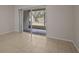 Bright living room with tile floors and sliding glass doors to the patio at 1118 Kennewick Ct, Wesley Chapel, FL 33543