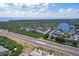Aerial view of the apartment complex showing buildings, trees, lake and surrounding area at 11901 4Th N St # 8207, St Petersburg, FL 33716