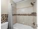 Clean bathroom showcasing shower, bathtub, patterned tile backsplash, and silver hardware at 11901 4Th N St # 8207, St Petersburg, FL 33716