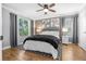 A stylish bedroom features ample natural light, modern decor, and wood flooring at 11901 4Th N St # 8207, St Petersburg, FL 33716