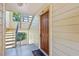 Condo entrance featuring a wood door, light-colored siding, and stairway access at 11901 4Th N St # 8207, St Petersburg, FL 33716