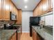Functional kitchen with wood cabinetry, granite counters, and modern appliances at 11901 4Th N St # 8207, St Petersburg, FL 33716