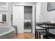 A closet features a washing machine, with kitchen appliances and dining table visible in background at 11901 4Th N St # 8207, St Petersburg, FL 33716