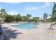 Resort-style pool area with lounge chairs, palm trees, and clear blue water for relaxation at 11901 4Th N St # 8207, St Petersburg, FL 33716