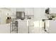 Clean, white kitchen featuring an island with seating and stainless steel appliances at 11938 Brae Way, Dade City, FL 33525