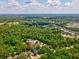 An aerial view showcases the property surrounded by lush greenery at 12212 Mcmullen Loop, Riverview, FL 33569