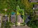Aerial view of the property showcasing its location, backyard, and proximity to neighboring homes in a tree-lined area at 12212 Mcmullen Loop, Riverview, FL 33569