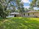 View of the rear exterior with a well-maintained lawn at 12212 Mcmullen Loop, Riverview, FL 33569