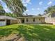 View of the rear exterior with a well-maintained lawn at 12212 Mcmullen Loop, Riverview, FL 33569
