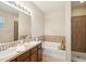 Bright bathroom featuring a double vanity, soaking tub and a separate shower with tiled walls at 12212 Mcmullen Loop, Riverview, FL 33569