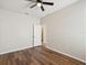 This bedroom features wood-look floors, base molding and an ensuite bathroom at 12212 Mcmullen Loop, Riverview, FL 33569