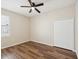 Bedroom with wood floors, closet, ceiling fan, and large window at 12212 Mcmullen Loop, Riverview, FL 33569