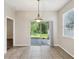 Cozy dining area featuring ceramic floors, modern pendant lighting and a sliding glass door to the outside at 12212 Mcmullen Loop, Riverview, FL 33569