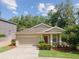 Charming single-story home featuring a well-maintained lawn and a two-car garage with neutral paint at 12212 Mcmullen Loop, Riverview, FL 33569