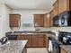 Beautiful kitchen featuring granite countertops, wood cabinets, and stainless steel appliances at 12212 Mcmullen Loop, Riverview, FL 33569