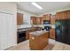 Well-equipped kitchen with a granite island, wooden cabinets, and stainless steel appliances at 12212 Mcmullen Loop, Riverview, FL 33569