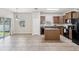 Bright kitchen with an island, granite countertops, wooden cabinets, and stainless steel appliances at 12212 Mcmullen Loop, Riverview, FL 33569