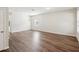 Spacious living room with wood floors, a modern light fixture, and natural light from large windows at 12212 Mcmullen Loop, Riverview, FL 33569