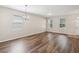 Large living room with wood floors, a chandelier-style light, and plenty of natural light from the windows at 12212 Mcmullen Loop, Riverview, FL 33569