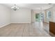 Open concept living room with neutral paint, lots of space, and a sliding glass door at 12212 Mcmullen Loop, Riverview, FL 33569