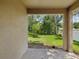 A covered back patio with view of lush trees at 12212 Mcmullen Loop, Riverview, FL 33569