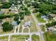 Aerial view of a house featuring a manicured lawn, pool and a circular driveway at 12501 Palomino Ct, Tampa, FL 33626