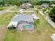 Aerial view of home with screened pool and mature landscaping and surrounding neighborhood at 12501 Palomino Ct, Tampa, FL 33626