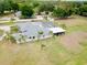 Aerial view of large home featuring a screened pool, large yard, and mature trees at 12501 Palomino Ct, Tampa, FL 33626