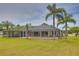 Expansive backyard featuring a screened-in pool area and lush landscaping at 12501 Palomino Ct, Tampa, FL 33626