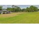 Spacious backyard with a screened-in pool and plenty of green space for outdoor activities at 12501 Palomino Ct, Tampa, FL 33626