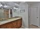 Bright bathroom with a double sink vanity, granite countertops, and a glass-enclosed shower at 12501 Palomino Ct, Tampa, FL 33626