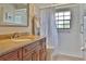 Well-lit bathroom with a shower-tub, wood cabinets, stone countertops, and neutral walls at 12501 Palomino Ct, Tampa, FL 33626