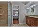 Bathroom featuring tiled floors, a tiled shower, and wood cabinets with stone countertops at 12501 Palomino Ct, Tampa, FL 33626