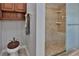 Bathroom with a tiled shower, built-in shelves, and unique toilet design at 12501 Palomino Ct, Tampa, FL 33626