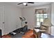 Exercise room with a treadmill, stationary bike, leather chair, and wood floor at 12501 Palomino Ct, Tampa, FL 33626