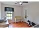 Bedroom with a wood floor and a sewing machine on a table in front of a window at 12501 Palomino Ct, Tampa, FL 33626