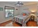 Bedroom with a ceiling fan, hardwood floors and a window with a view of the outdoors at 12501 Palomino Ct, Tampa, FL 33626