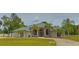 Stunning single-story home with a well-manicured lawn and an elegant, arched entryway framed by columns at 12501 Palomino Ct, Tampa, FL 33626