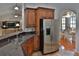 Kitchen with stainless steel appliances, granite countertops and a view into the dining room at 12501 Palomino Ct, Tampa, FL 33626