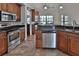 Spacious kitchen with stainless steel appliances, granite countertops, tile floor and dark wood cabinetry at 12501 Palomino Ct, Tampa, FL 33626
